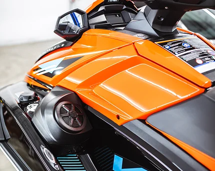 Close-up of an orange Yamaha VX personal watercraft, highlighting its integrated marine audio speaker system and sleek design details.
