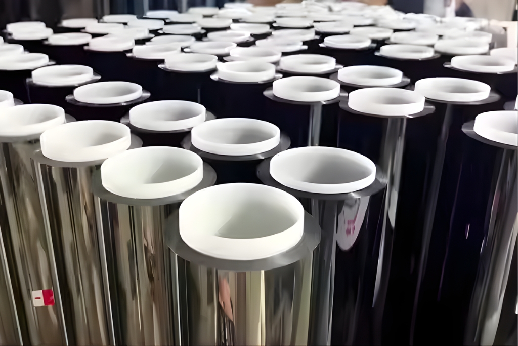 Multiple rolls of window tint film in a Fort Myers facility, showing various finishes used for different types of commercial window film.