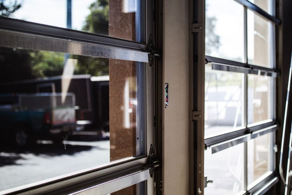 Sunlight streams through large glass garage-style doors in a Fort Myers commercial space, illustrating the need for added protection and UV control. This setting shows why many local businesses are opting for Security Window Film to enhance safety, reduce glare, and improve energy efficiency.